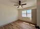Cozy bedroom with wood-look floors, a ceiling fan, and a bright window at 1312 Tuscola St, Clearwater, FL 33756