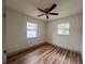 Empty bedroom with light wood floors and updated windows providing natural light at 1312 Tuscola St, Clearwater, FL 33756