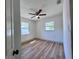 Bright bedroom with wood-look floors and a ceiling fan, showcasing a peaceful ambiance at 1312 Tuscola St, Clearwater, FL 33756