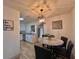 Cozy dining area featuring a modern chandelier and views into the updated kitchen at 1312 Tuscola St, Clearwater, FL 33756