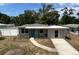 Charming single-story home featuring a bright blue door, well-maintained lawn, and inviting walkway, perfect for first-time buyers at 1312 Tuscola St, Clearwater, FL 33756