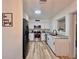 Updated kitchen with stainless steel appliances, white cabinets, and granite countertops at 1312 Tuscola St, Clearwater, FL 33756