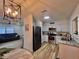 Open kitchen with modern appliances, white cabinets and seamless flow to living area at 1312 Tuscola St, Clearwater, FL 33756