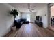 Large living room featuring wood-look floors, a ceiling fan, a modern sectional, and a television at 1312 Tuscola St, Clearwater, FL 33756