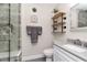 Bathroom with tiled shower, floating shelves, and a white vanity at 13596 Croft N Dr, Largo, FL 33774