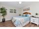Bright bedroom featuring wood floors, a large window, and comfortable-looking decor and accents at 13596 Croft N Dr, Largo, FL 33774
