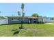 Charming home with a well-maintained front lawn, inviting porch, and a welcoming exterior at 13596 Croft N Dr, Largo, FL 33774