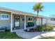 Charming home featuring a cozy front porch with a bench, landscaping, and a well-manicured lawn at 13596 Croft N Dr, Largo, FL 33774