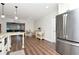 Bright kitchen open to living area with stainless steel appliances and granite counters at 13596 Croft N Dr, Largo, FL 33774