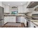 Bright kitchen with white cabinets, stainless steel appliances, and granite countertops at 13596 Croft N Dr, Largo, FL 33774
