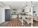 Kitchen features granite countertops, stainless steel appliances, and center marble breakfast table with white wooden base at 13596 Croft N Dr, Largo, FL 33774