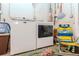 Bright laundry room featuring a modern Maytag washer and dryer set with some fun decorations at 13596 Croft N Dr, Largo, FL 33774