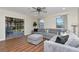Bright living room with a gray sectional sofa, windows, and screened-in porch view at 13596 Croft N Dr, Largo, FL 33774