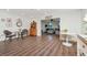 Open living space with wood floors, dining area, and comfortable lounge seating at 13596 Croft N Dr, Largo, FL 33774