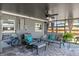 Screened-in patio with comfortable seating, a ceiling fan, and tiled flooring for relaxation and entertaining at 13596 Croft N Dr, Largo, FL 33774