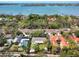 An aerial view of a house with a screened-in pool, set near the waterfront and surrounded by mature trees at 1433 Park N St, St Petersburg, FL 33710