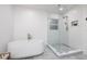 Bright bathroom featuring a modern soaking tub and glass-enclosed shower at 1433 Park N St, St Petersburg, FL 33710