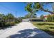 Exterior side view of home shows a spacious driveway leading to a screened in porch at 1433 Park N St, St Petersburg, FL 33710