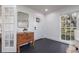 Hallway showcasing dark hardwood floors, white walls, a charming wooden chest, and natural light at 1433 Park N St, St Petersburg, FL 33710