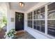 Close-up of the front door with a stylish wreath, adjacent to a large window at 1433 Park N St, St Petersburg, FL 33710