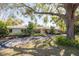 Front exterior view of a ranch style home, showcasing mature trees and a beautiful lawn at 1433 Park N St, St Petersburg, FL 33710