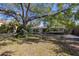 Charming single-story home with a long driveway and mature trees in a lush landscape at 1433 Park N St, St Petersburg, FL 33710