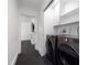 Modern laundry room with front-loading washer and dryer units, storage cabinets, and minimalist design at 1433 Park N St, St Petersburg, FL 33710