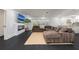 Open-concept living room with a fireplace, TV, and large sectional couch at 1433 Park N St, St Petersburg, FL 33710
