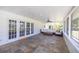 Cozy screened patio with comfortable seating, slate floors, and a serene view, perfect for outdoor relaxation at 1433 Park N St, St Petersburg, FL 33710