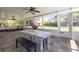 Inviting screened patio with casual dining area, slate floors, and scenic backyard views for outdoor enjoyment at 1433 Park N St, St Petersburg, FL 33710
