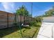 Backyard playground area near a fence and mature landscaping at 1433 Park N St, St Petersburg, FL 33710