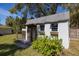 Wooden shed with double doors surrounded by lush landscaping at 1433 Park N St, St Petersburg, FL 33710