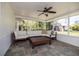 Relaxing sunroom featuring a neutral sectional sofa, ceiling fan and slate tile flooring at 1433 Park N St, St Petersburg, FL 33710