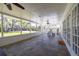 Spacious sunroom featuring slate tile flooring, views of the backyard, and access to the house and yard at 1433 Park N St, St Petersburg, FL 33710