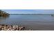 Expansive view of serene waterfront featuring a rocky shoreline and calm waters, with a distant cityscape at 1433 Park N St, St Petersburg, FL 33710