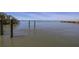 Calm waterfront view with wooden posts in water, bridge in the distance, and clear horizon at 1433 Park N St, St Petersburg, FL 33710