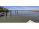 Scenic waterfront view with calm waters, a nearby pier, and docked boat, creating a peaceful coastal setting at 1433 Park N St, St Petersburg, FL 33710