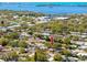 A birds eye view of the neighborhood showcasing mature trees and the home's location at 1521 San Helen Dr, Dunedin, FL 34698