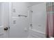Bright bathroom with bathtub, toilet, and white tiled walls at 1521 San Helen Dr, Dunedin, FL 34698