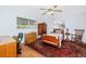 Bedroom with wood furniture, two windows, and an area rug at 1521 San Helen Dr, Dunedin, FL 34698