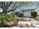 Charming single-story home featuring mature trees, landscaped yard and a two-car garage at 1521 San Helen Dr, Dunedin, FL 34698
