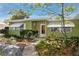 Charming single-story home with a landscaped front yard and a welcoming entrance at 1521 San Helen Dr, Dunedin, FL 34698