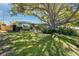 Single Gathering home featuring a landscaped front yard with a mature shade tree at 1521 San Helen Dr, Dunedin, FL 34698