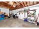 Unfinished garage with laundry area, storage shelving, and an exposed rafter ceiling at 1521 San Helen Dr, Dunedin, FL 34698