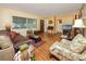 Cozy living room with hardwood floors, a couch, and a floral armchair at 1521 San Helen Dr, Dunedin, FL 34698