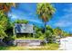 Welcoming sign for Honeymoon Island State Park, surrounded by lush tropical vegetation at 1521 San Helen Dr, Dunedin, FL 34698