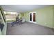Enclosed porch area featuring a concrete floor, a ceiling, and access via a set of double doors at 1521 San Helen Dr, Dunedin, FL 34698
