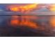 Stunning waterfront view with vibrant sunset colors reflecting on the calm water and sky at 1521 San Helen Dr, Dunedin, FL 34698