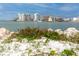 Scenic waterfront view showcasing a tranquil bay with sailboats and modern buildings across the shore at 1521 San Helen Dr, Dunedin, FL 34698