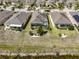 Aerial view of a house with a screened-in pool and landscaped backyard at 1647 Emerald Dunes Dr, Sun City Center, FL 33573